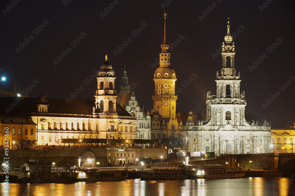 Night view of the city with royal palace buildings and reflections in the Elbe river in Dresden, Germany.