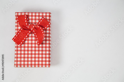 Top view of red gift box on white background. Space for product placement. Minimal concept. © Milica