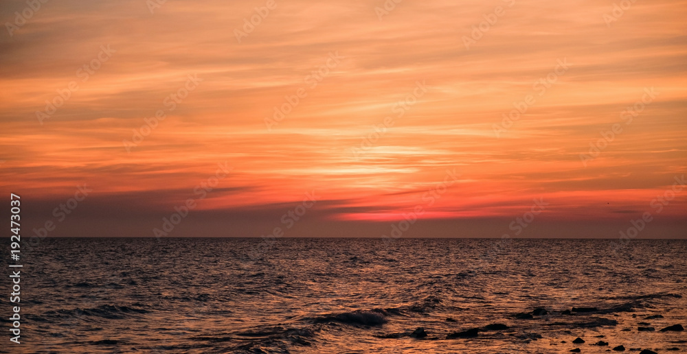 Beautiful colorful sunrise at the sea with clouds in the red sky. Beautiful colorful sunrise at the sea with clouds in the red sky.