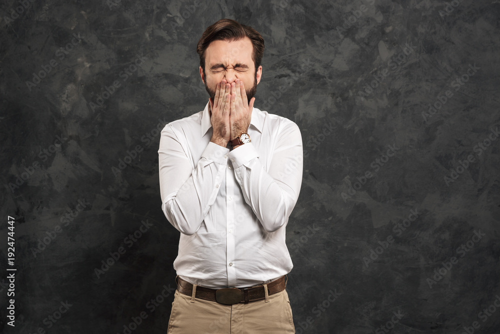 Portrait of a young man dressed white shirt sneezing Portrait of a young man dressed white shirt sneezing