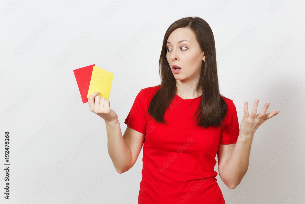 European serious severe young woman, football referee hold choose yellow and red soccer cards, propose player retire from field isolated on white background. Sport, play, healthy lifestyle concept. European serious severe young woman, football referee hold choose yellow and red soccer cards, propose player retire from field isolated on white background. Sport, play, healthy lifestyle concept.