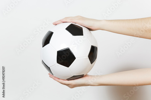 Female hands horizontal holding soccer classic white black ball isolated on white background. Sport, play football, health, healthy lifestyle concept.