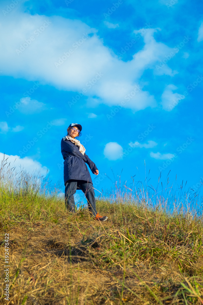 Beautiful woman standing on mountain with blue sky. Beautiful woman standing on mountain with blue sky.
