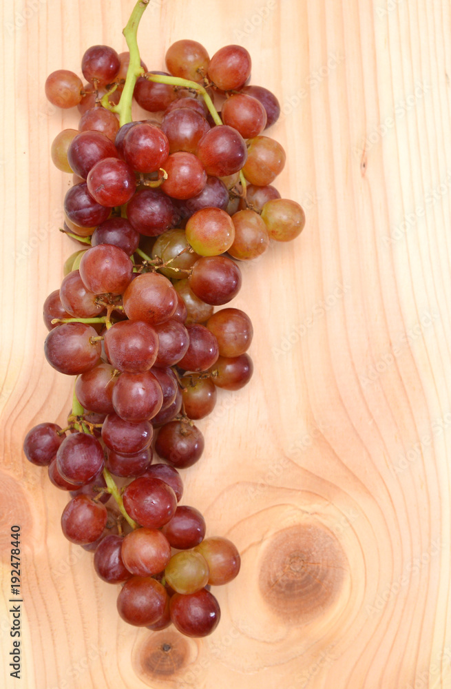 red grapes isolated on wood background red grapes isolated on wood background