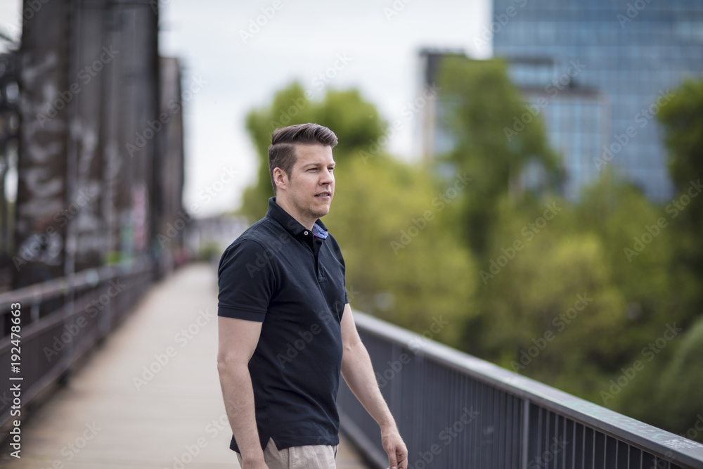 Portrait of a Handsome Man Walking on a City Bridge Portrait of a Handsome Man Walking on a City Bridge