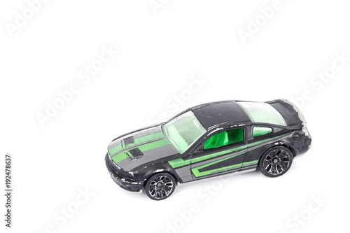 Black toy car isolated on white background. © nayladen