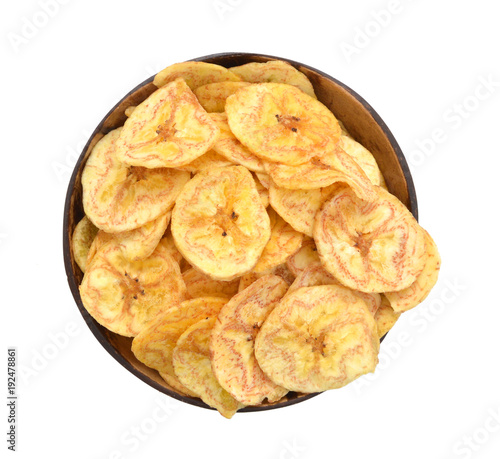 Banana chips in wood bowl on white background