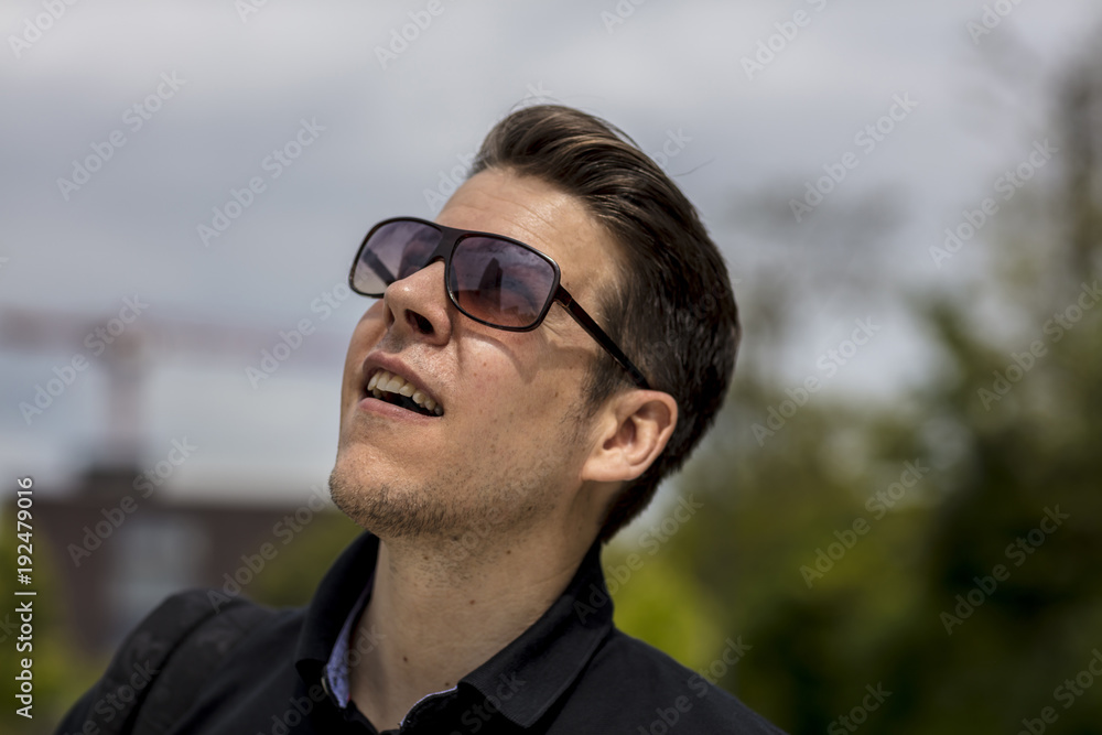 Headshot of Man With Sunglasses Looking Up at the Sky Headshot of Man With Sunglasses Looking Up at the Sky