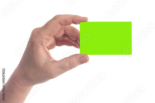 Left hand holds blank green business card - isolated on white background with copyspace