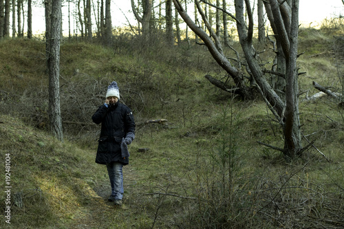 woman on mobile phone in wood walk