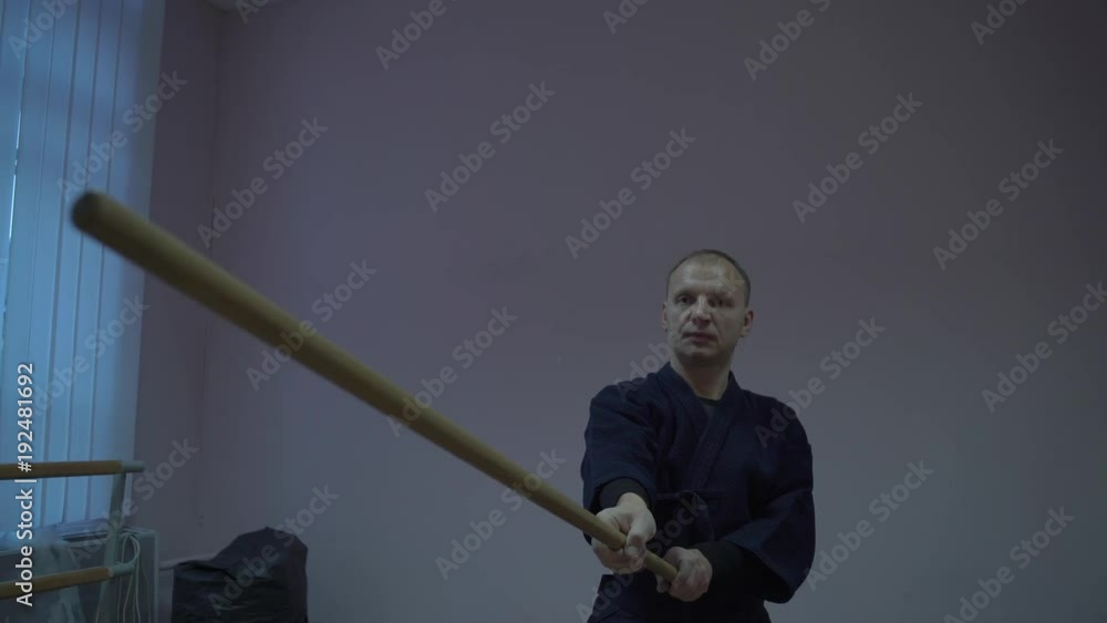 Master Kendo Trains in the Hall with a Wooden Stick Performs a Kata Master Kendo Trains in the Hall with a Wooden Stick Performs a Kata