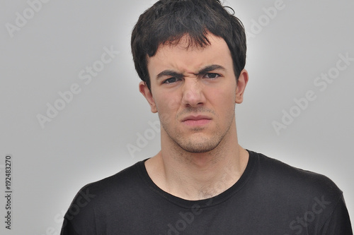 portrait of a frowning young man on a white background