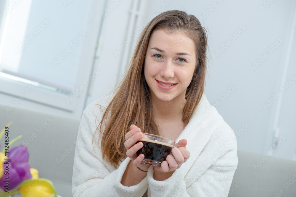 at morning, young and smiling woman drinking coffee at morning, young and smiling woman drinking coffee