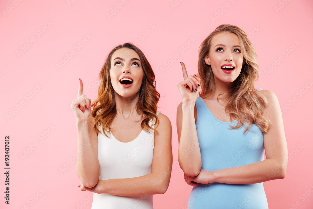 Portrait of a two cheerful girls dressed in swimsuits Portrait of a two cheerful girls dressed in swimsuits