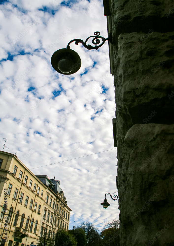 Old Balcony Street Lamp on Stone Wall against European City