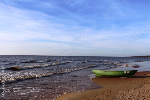 Riga Seaside, Latvia, March 2014: Green boat on the Baltic Sea beach