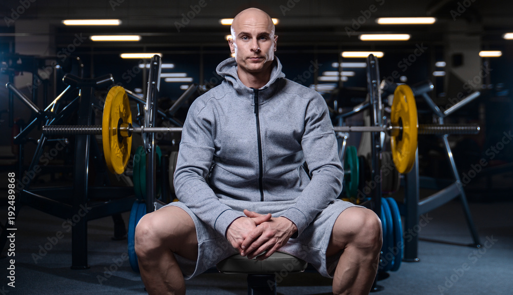 Brutal strong bodybuilder athletic men pumping up muscles with dumbbells Brutal strong bodybuilder athletic men pumping up muscles with dumbbells