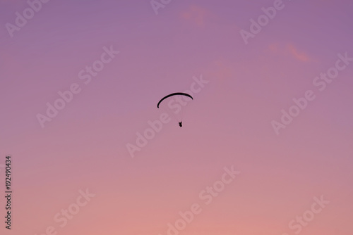 Fototapeta Naklejka Na Ścianę i Meble -  Paraglide shilouette at dusk