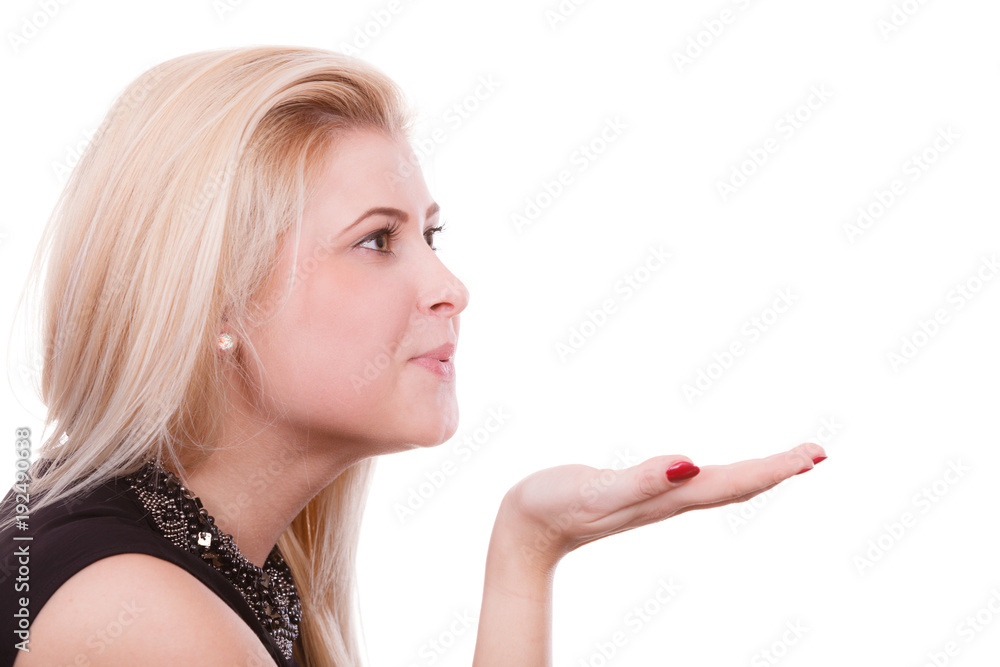 Blonde woman sending air kiss on palm hand Blonde woman sending air kiss on palm hand