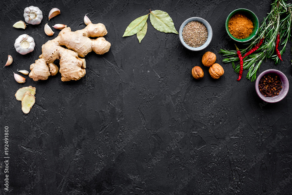 Gastronomy, culinary. Secrets of tasty dishes. Seasoning and spices. Rosemary, ginger, chili pepper on black background top view copy space Gastronomy, culinary. Secrets of tasty dishes. Seasoning and spices. Rosemary, ginger, chili pepper on black background top view copy space