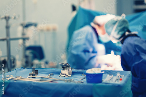 Surgical nurse pick up sterile instrument in the surgery operation room in hospital processing technician and surgical instrument technician, surgical technician operating room technician nurse. photo