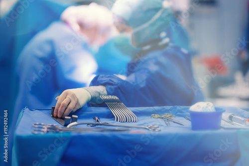 Quadro em tela Surgical nurse pick up sterile instrument in the surgery operation room in hospital processing technician and surgical instrument technician, surgical technician operating room technician nurse