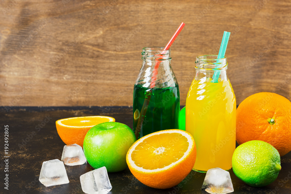 Drinks orange juice on tarragon in bottles with fresh fruit. Drinks orange juice on tarragon in bottles with fresh fruit.