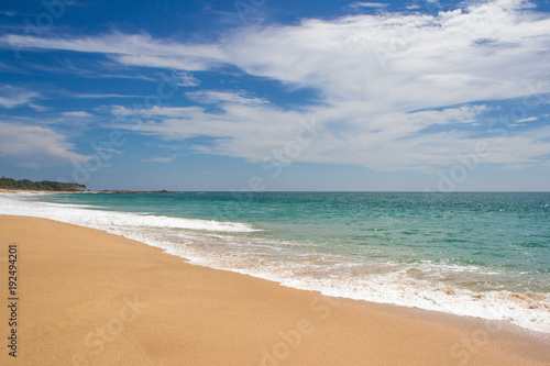 Beautiful beach. View of nice tropical beach with palms around. Holiday and vacation concept. Tropical beach.