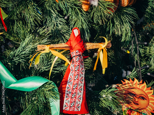 Rag Dolls on christmas tree on folk Slavic pagan holiday Maslenitsa of the end of winter. photo