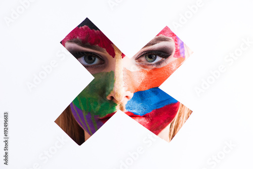 Close-up of a pretty girl with colorful face art © bodiaphoto