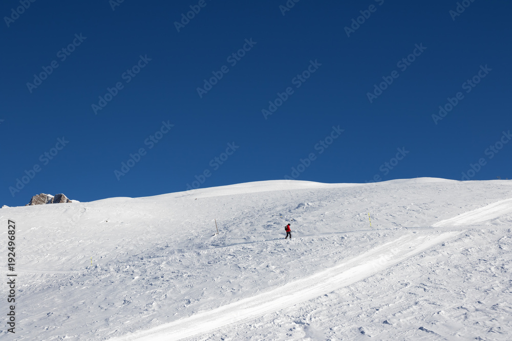 Snowboarder downhill on snowy slope