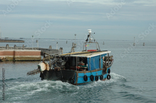 Fishing boat returning to harbor photo