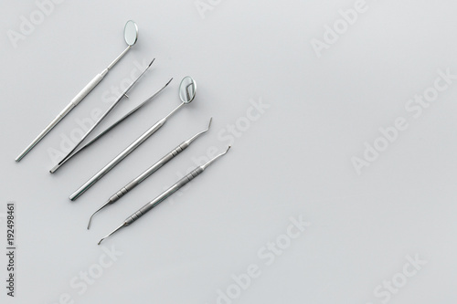 Dentist tools. Teethcare, dental health concept. Grey background top view copy space