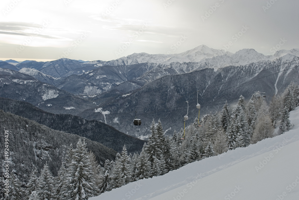 landscape: cableway lift, gondola, skilift, cabin, used by skiers to have pass at top of mountains to get off ski slopes, resort after a snowfall, Alps, Vigezzo Valley, Piedmont, Italy