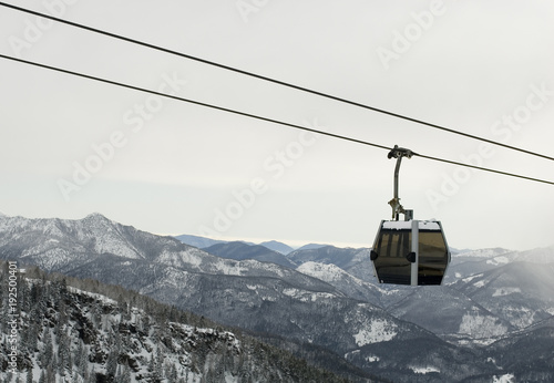 landscape: cableway lift, gondola, cabin, is used by skiers to have a pass at top of mountains to get off ski slopes, resort after a snowfall, Alps, Vigezzo Valley, Piedmont, Italy