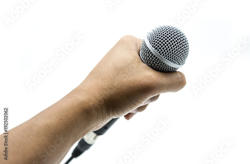 Hand is holding microphone on white background