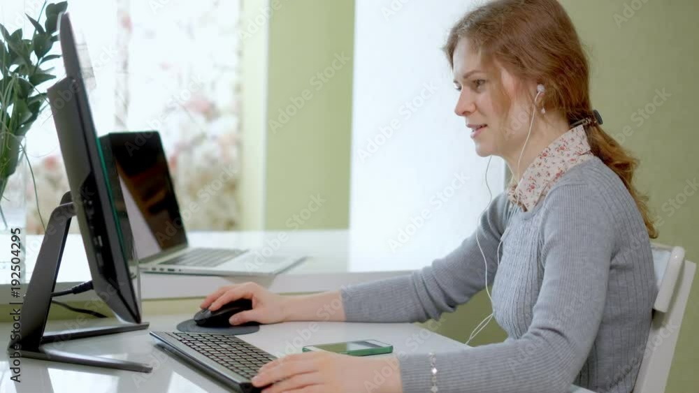 Young pretty business woman with computer and notebook in the home office Young pretty business woman with computer and notebook in the home office