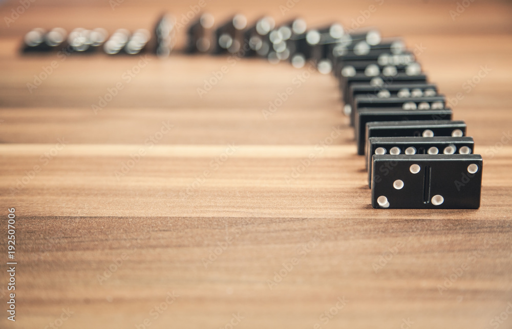 Game of domino on wood background.