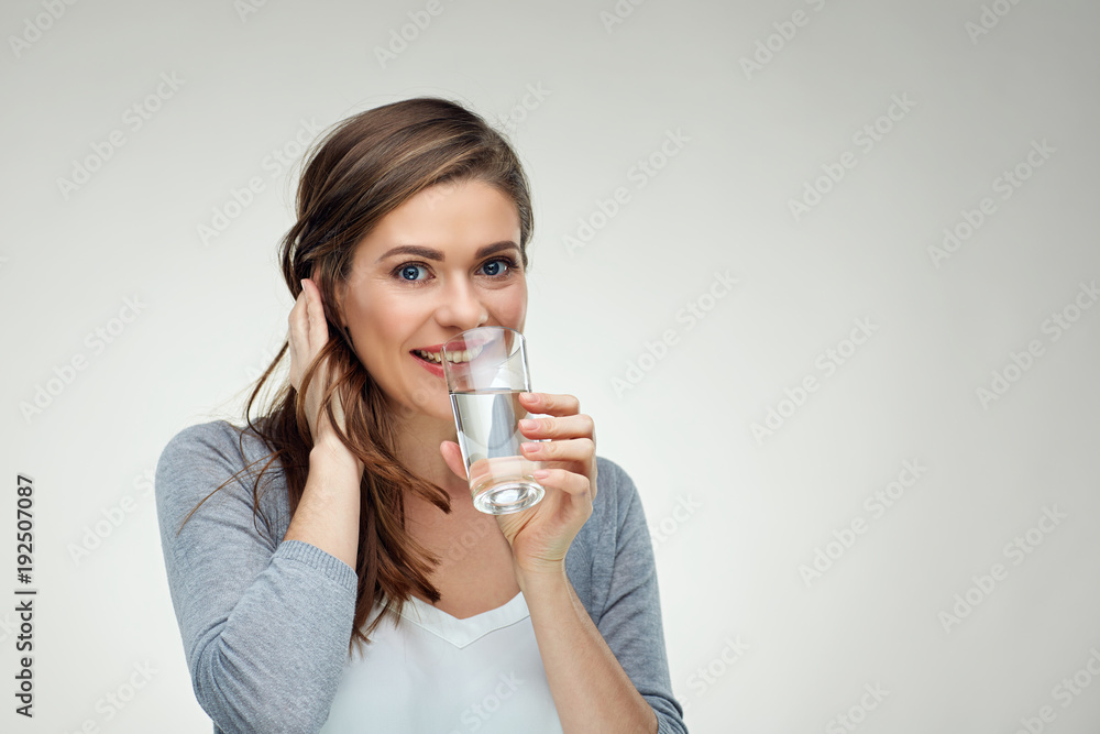 Smiling woman drinking water from glass. close up isolated face Smiling woman drinking water from glass. close up isolated face