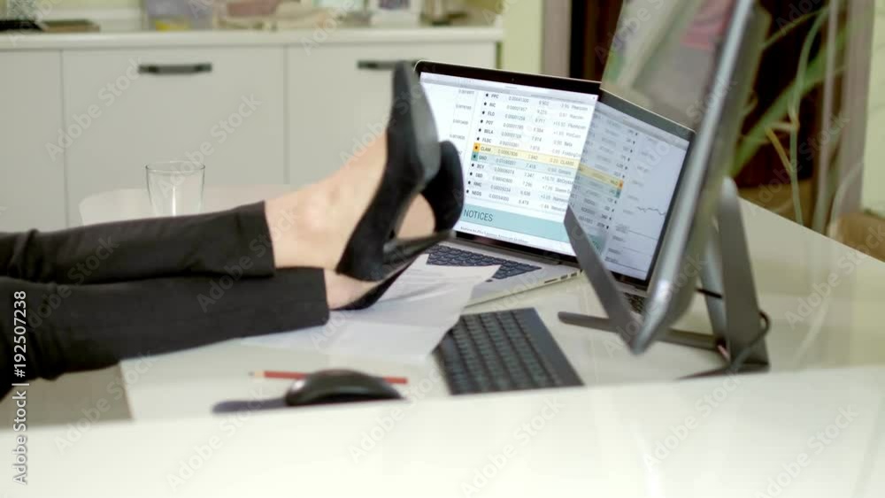 angry businesswoman with legs on the table relaxation angry businesswoman with legs on the table relaxation