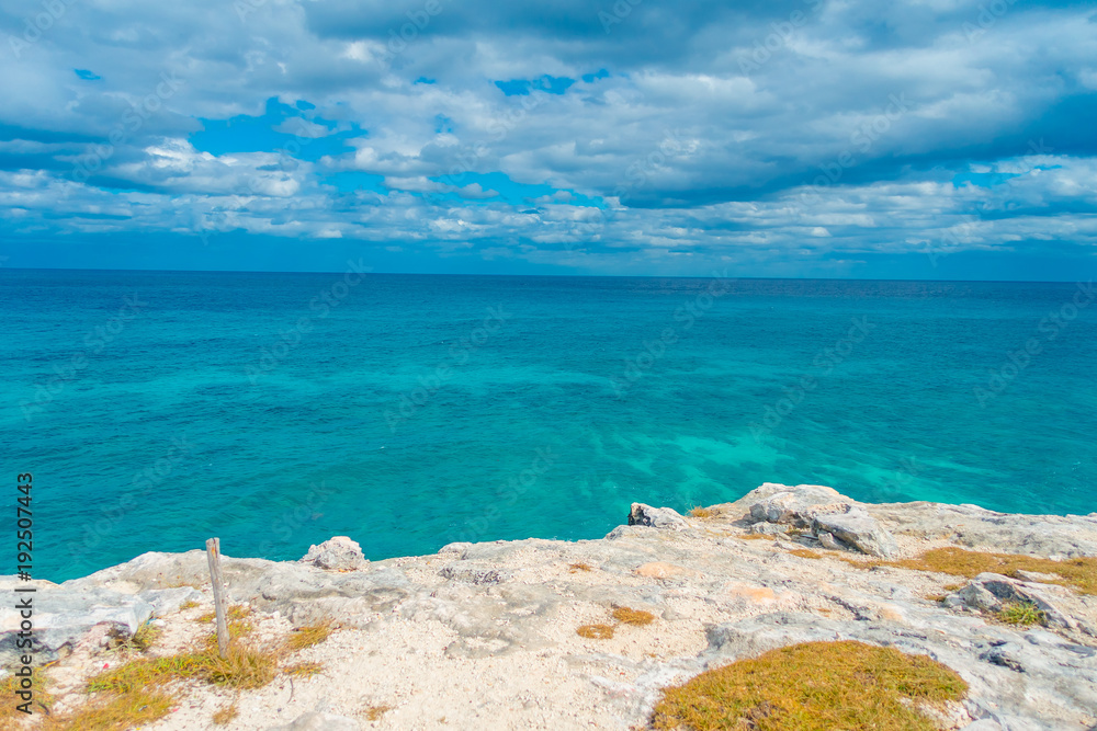 Beautiful outdoor view on the edge of the cliff Isla Mujeres Punta sun caribbean sea, with a turquoise water in Mexico