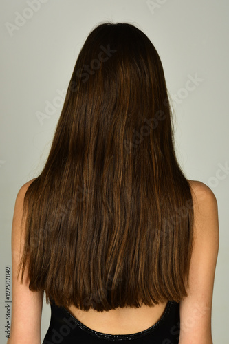 Woman with long brunette hair, back view
