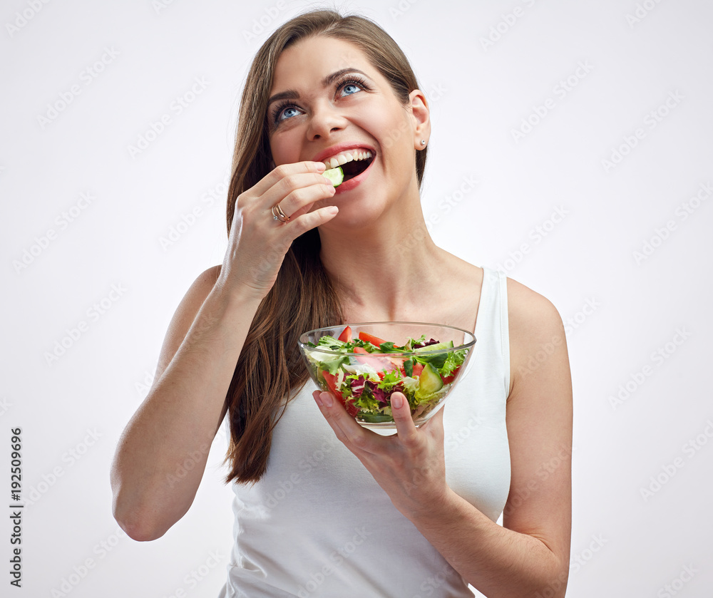 Beautiful smiling woman eating salad looking up. Beautiful smiling woman eating salad looking up.