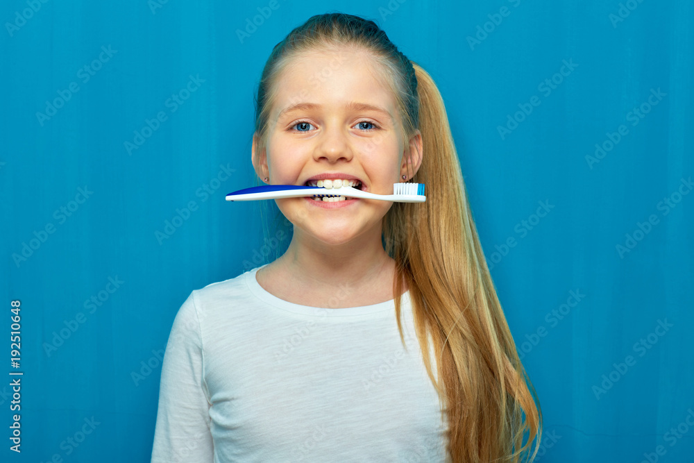Little girl holding toothy brush with teeth. Little girl holding toothy brush with teeth.