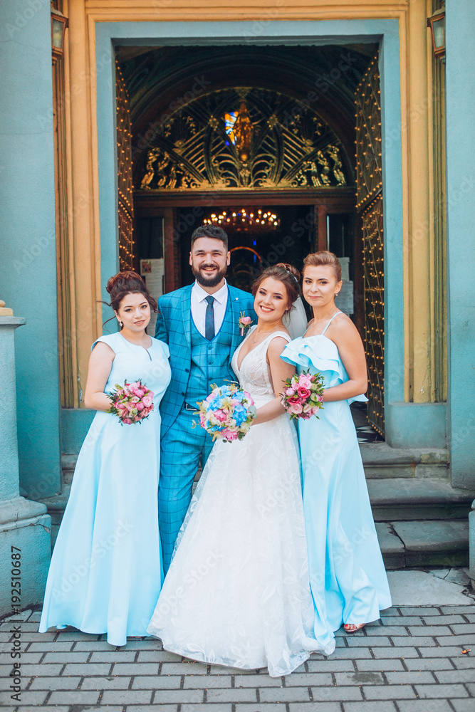 bride and groom newlyweds with happy groomsmans and bridesmaids posing at church after luxury wedding ceremony bride and groom newlyweds with happy groomsmans and bridesmaids posing at church after luxury wedding ceremony