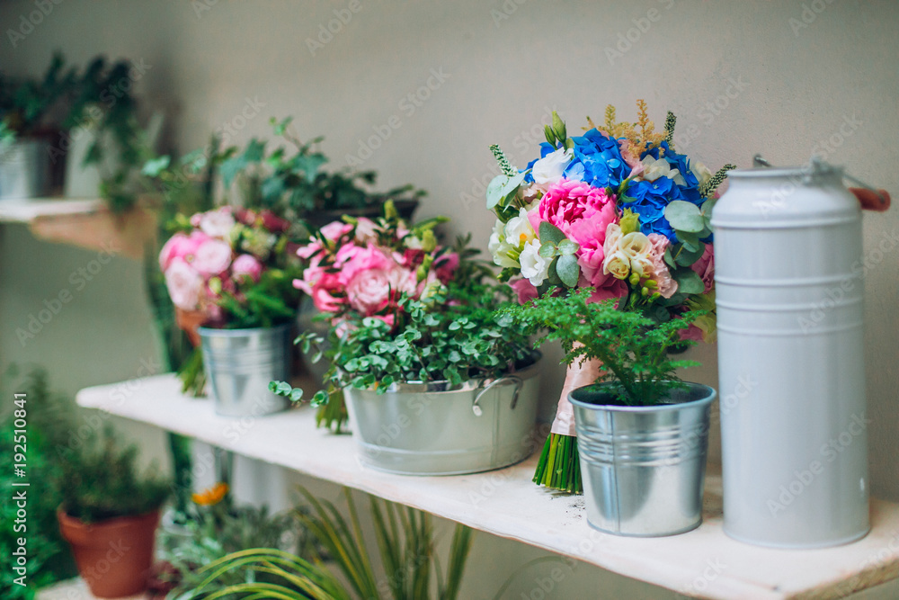 Obraz premium Bride showing off her beautiful boho flowers bouquet. Perfect image with copy space for: chic boho wedding magazines and websites, bohemian, fashion, florist and other related subjects.