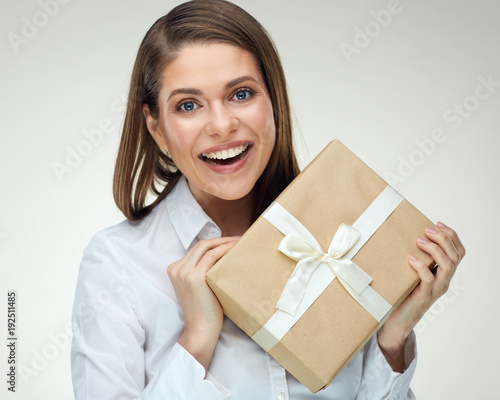 Businesswoman holding big gift box. Isolated portrait
