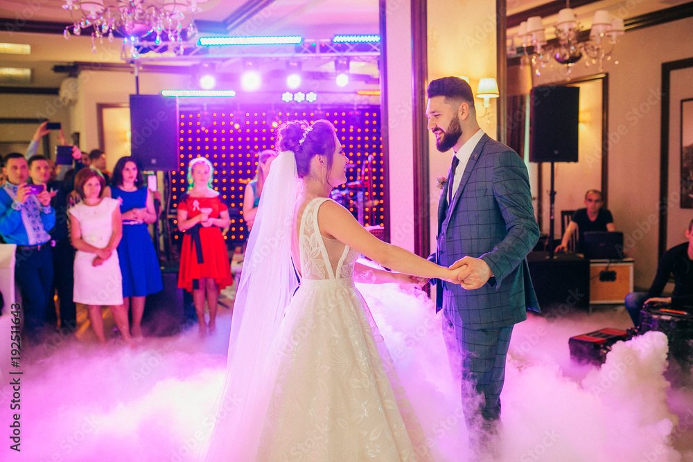 First dance the bride and groom in the smoke. brides wedding party in the elegant restaurant with a wonderful light and atmosphere