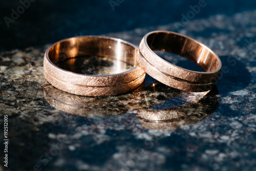 Wedding rings for newlyweds on a dark background photo