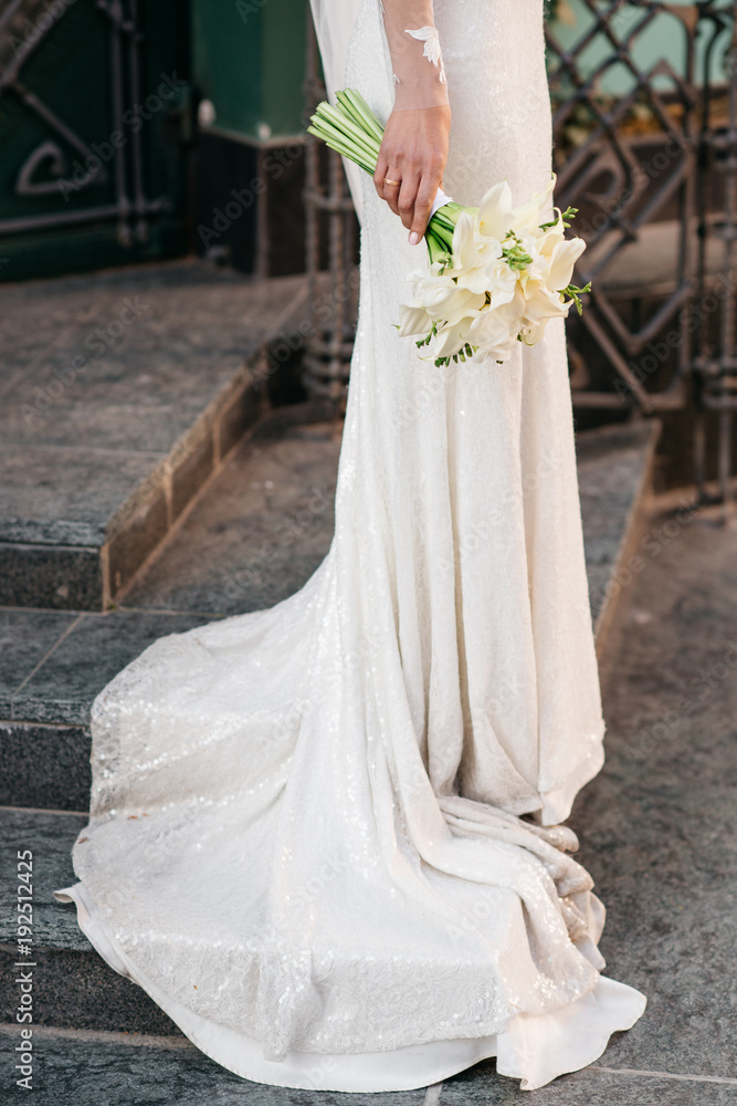 Bride holding beautiful white wedding flowers bouquet Bride holding beautiful white wedding flowers bouquet